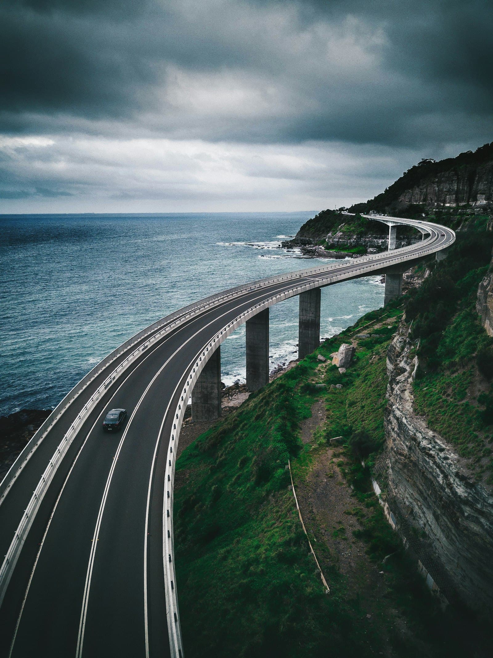 A bridge curving along a coastline